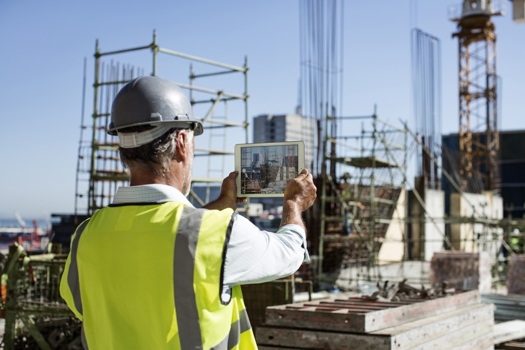 Male architect photographing construction site