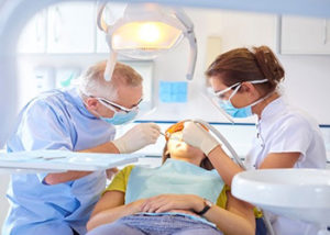 Dentist inspecting patient's mouth