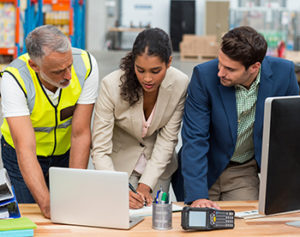 workers looking at computer screen together