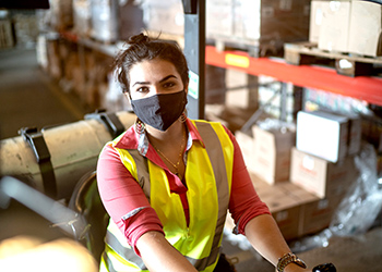 worker in safety vest and mask